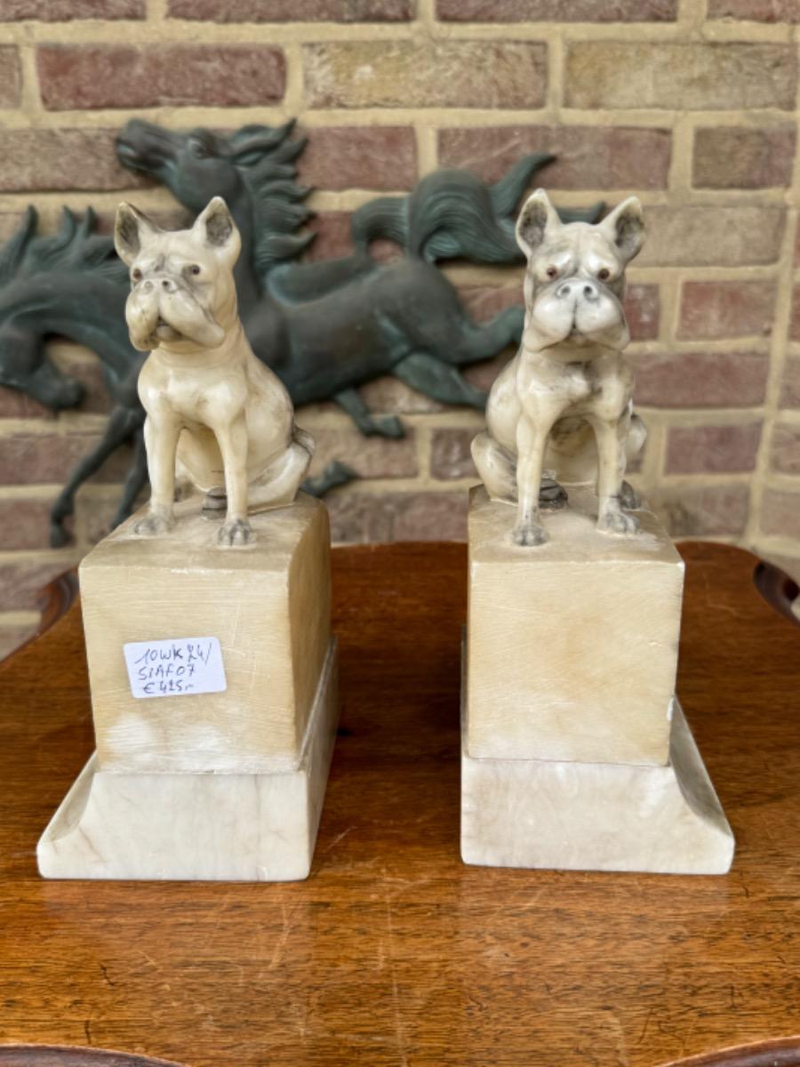 Alabaster book stands with dogs