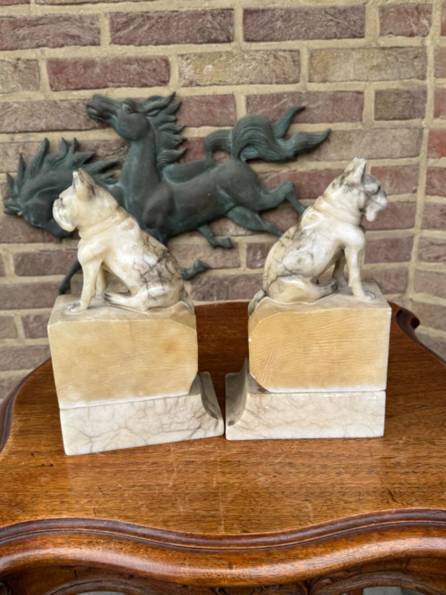 Alabaster book stands with dogs