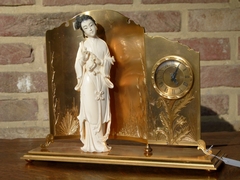 Asiatique style Clock with ivory made by Hour Lavigne in gilded bronze and ivory, France 1940