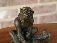 Signed with a V.1902 style Miniature bronze sculpture of a monkey in patinated bronze 1900